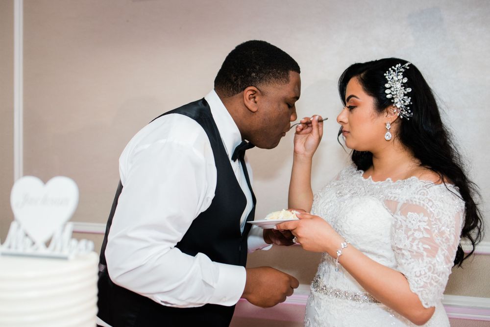 bride feeding wedding cake to groom