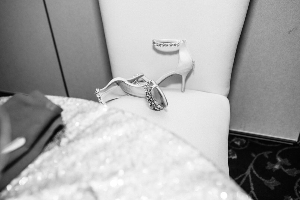 brides wedding shoes off laying on a chair in the reception