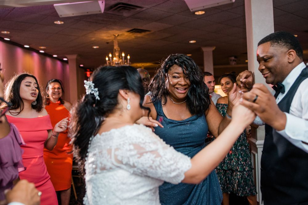 bride and groom and mother of the groom dancing on the dance floor