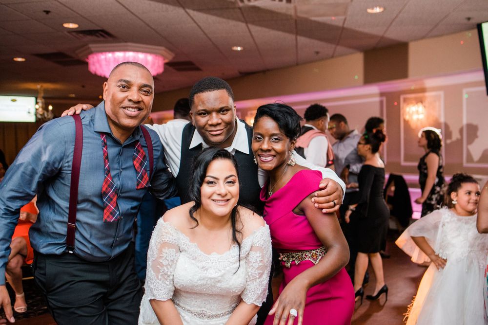 bride and groom posing with wedding guests