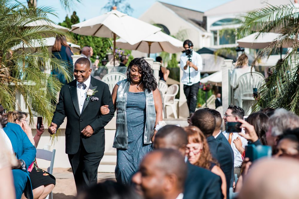 father and mother of the groom walking down the aisle