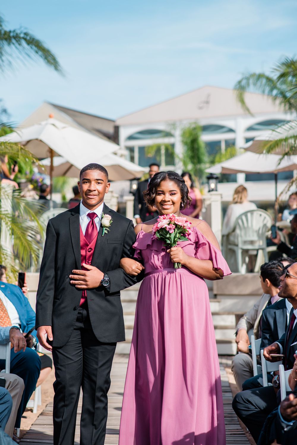 groomsmen and bridesmaid walking down the aisle
