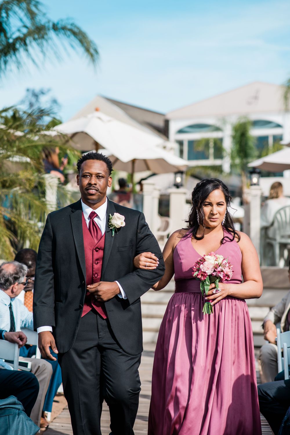groomsmen and bridesmaid walking down the aisle