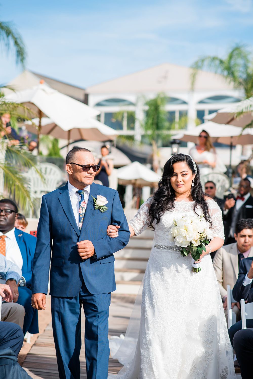 father and bride walking down the aisle