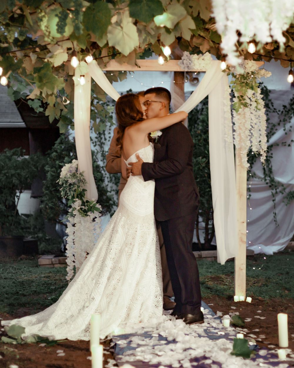 bride and groom's first kiss at the altar