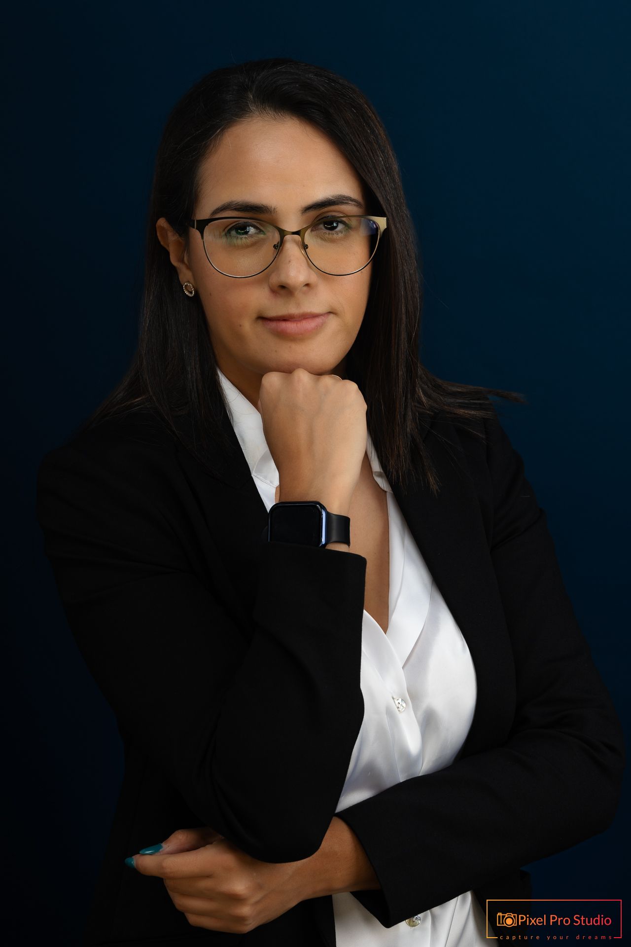 Professional business portrait series featuring dark suit and white shirt against navy background.