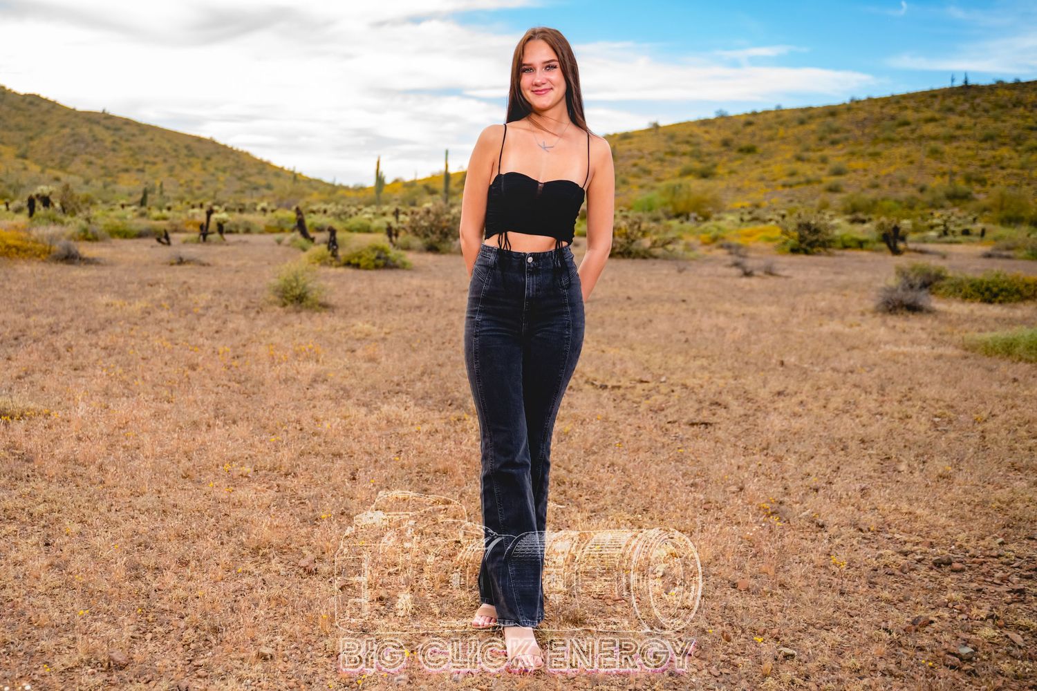 Beautiful female model, teen girl, barefoot, outdoors, Arizona desert, sunny, bright, wearing jeans and a black tank top
