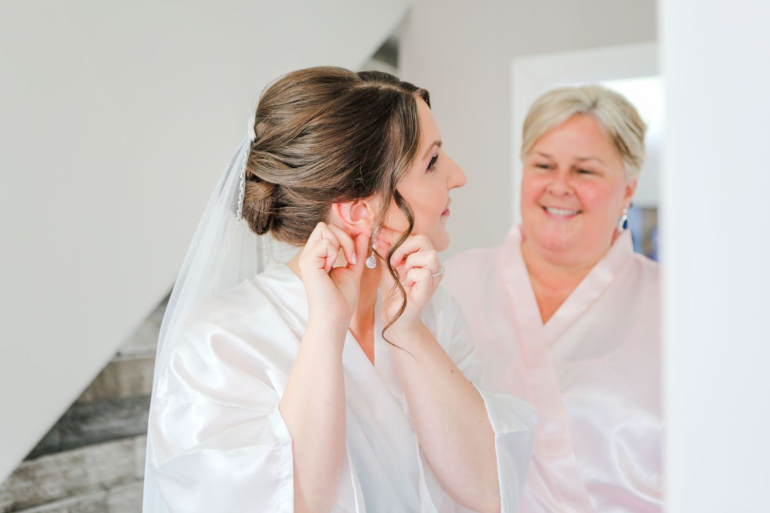Getting ready moments captured during wedding day preparations in a bright room.