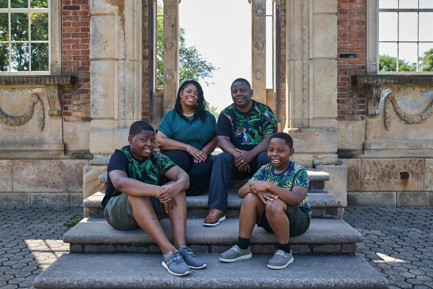 Group relaxing together on stone steps of historic brick building.
