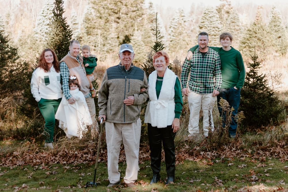 Group photo session outdoors with multiple families in casual attire.