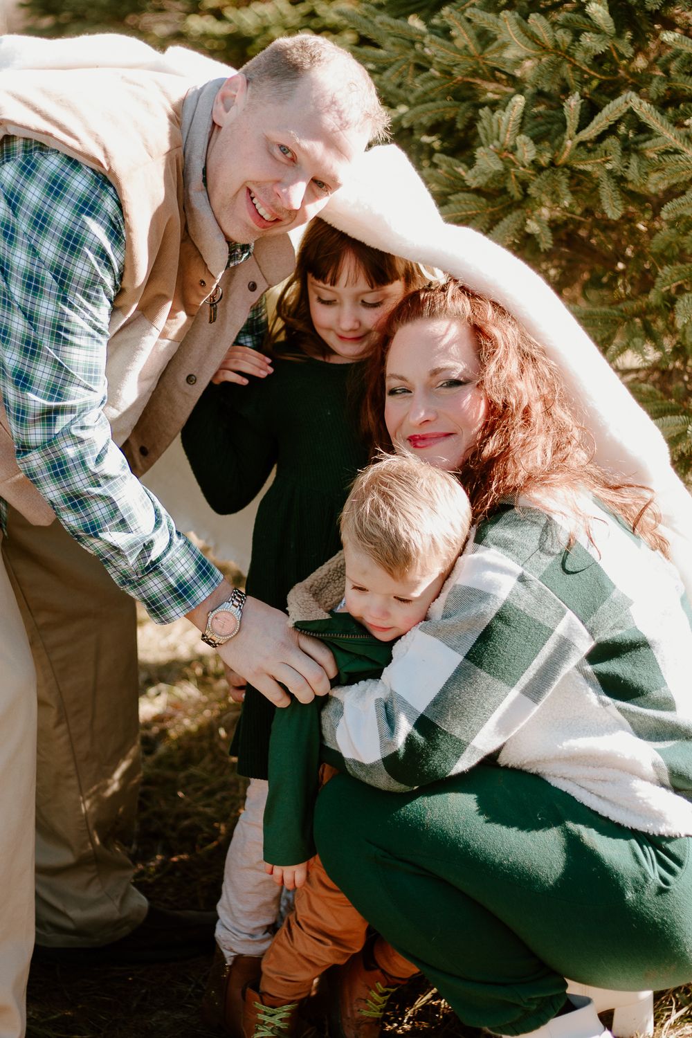 Intimate family portrait showing warm embraces and natural interactions.