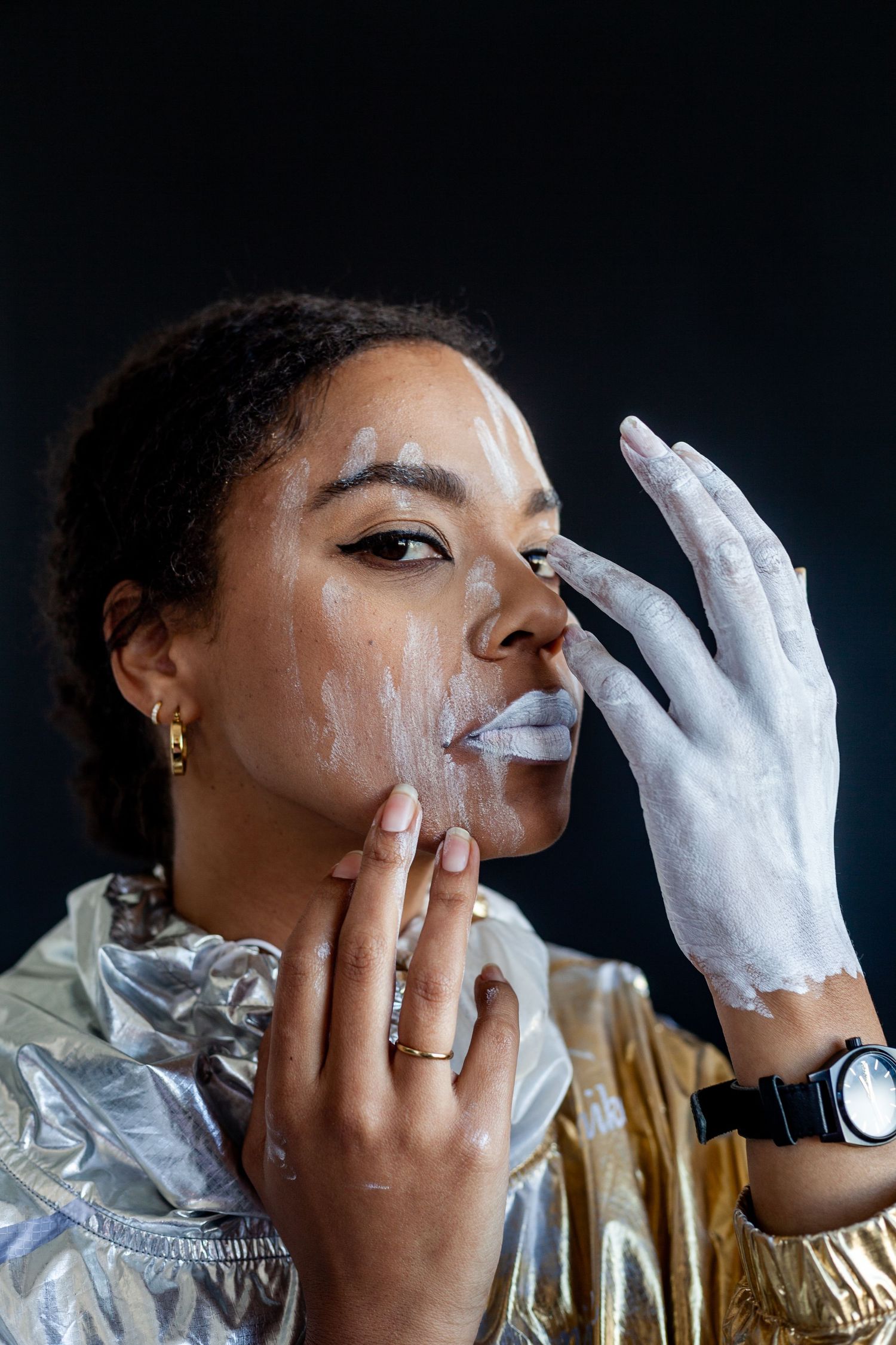 Artistic portrait series with white gloves and gold jacket showing dramatic facial expressions.