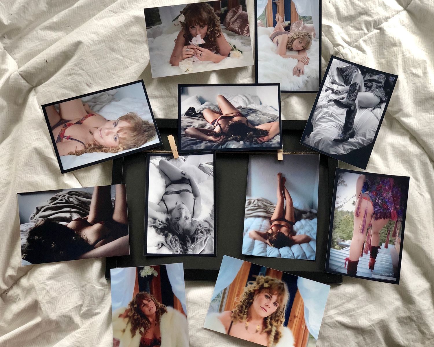 Collection of artistic boudoir photographs arranged on white fabric.
