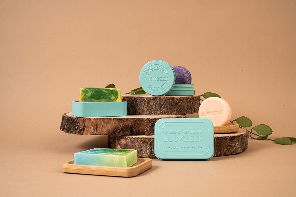 Eco-friendly soap bars displayed on wooden slices with minimalist turquoise aesthetics.