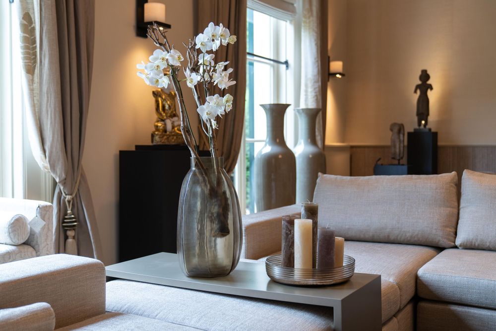 Modern living room with floral decor, neutral tones, and plush seating.