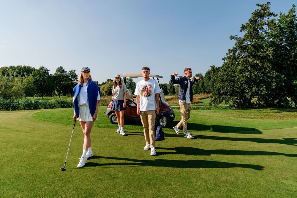 Group playing golf on a sunny green course during summer.