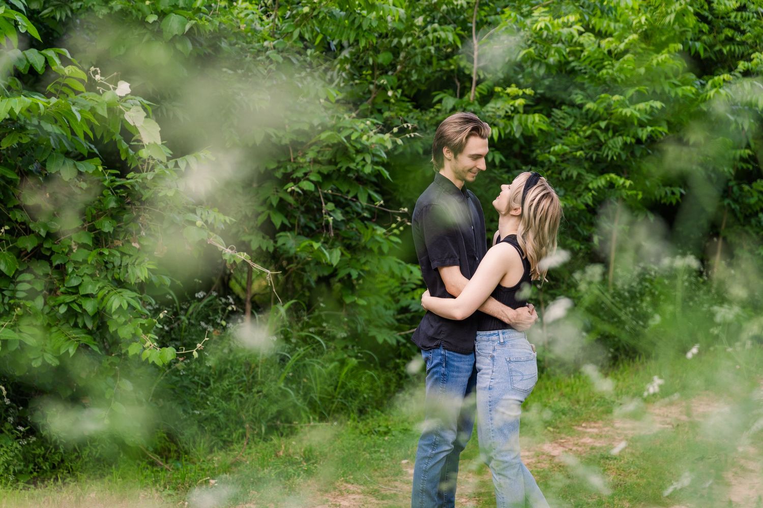 couple admiring each other in forest florwers