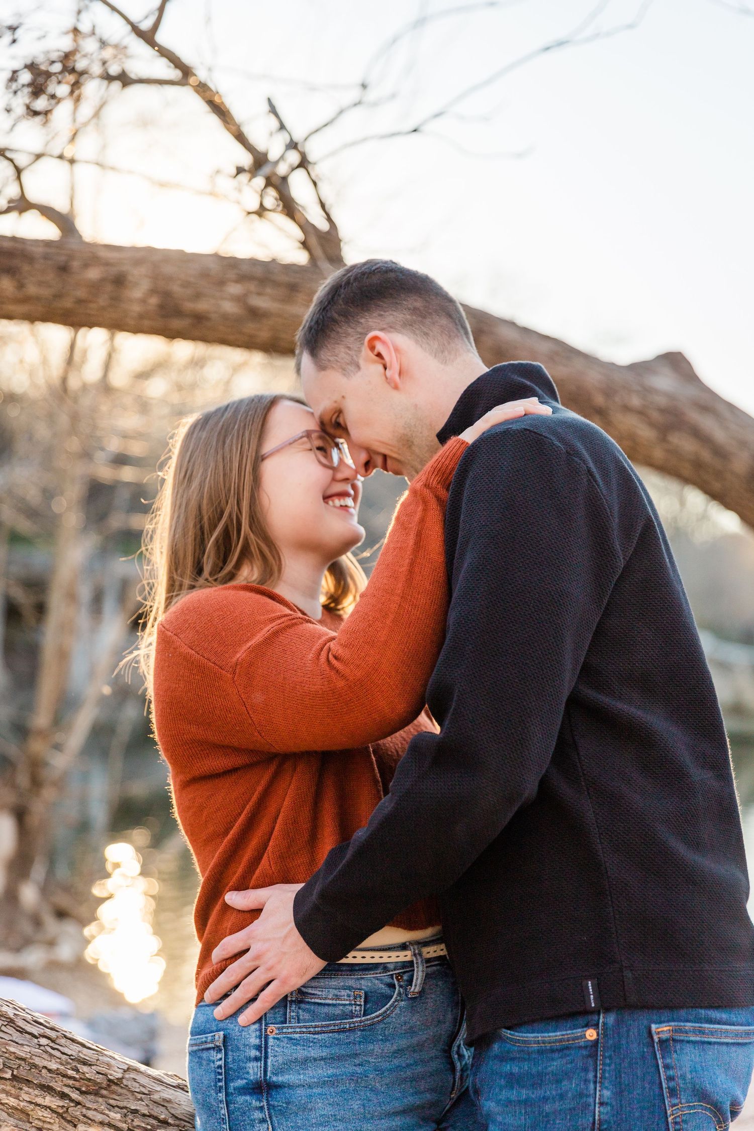 couple touching foreheads in fall engagement photo