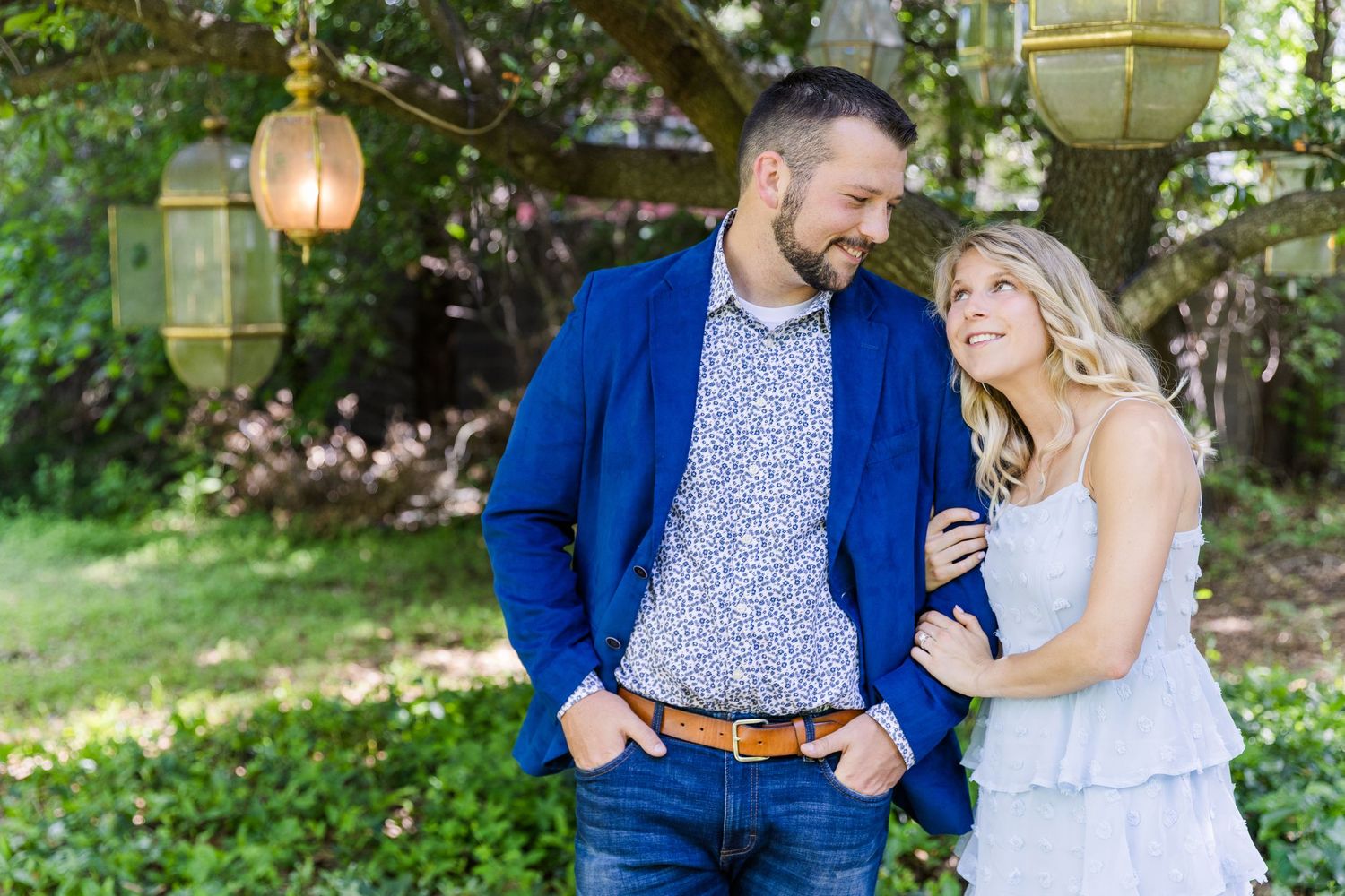 couple engaged at Sekrit Theater under tree lanterns