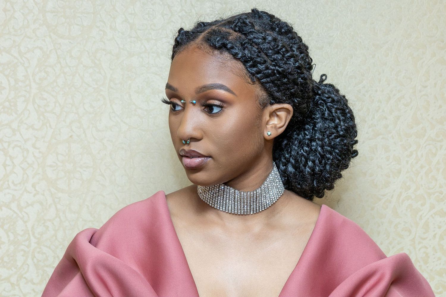 Elegant portrait featuring braided hairstyle, crystal choker and pink satin evening wear.