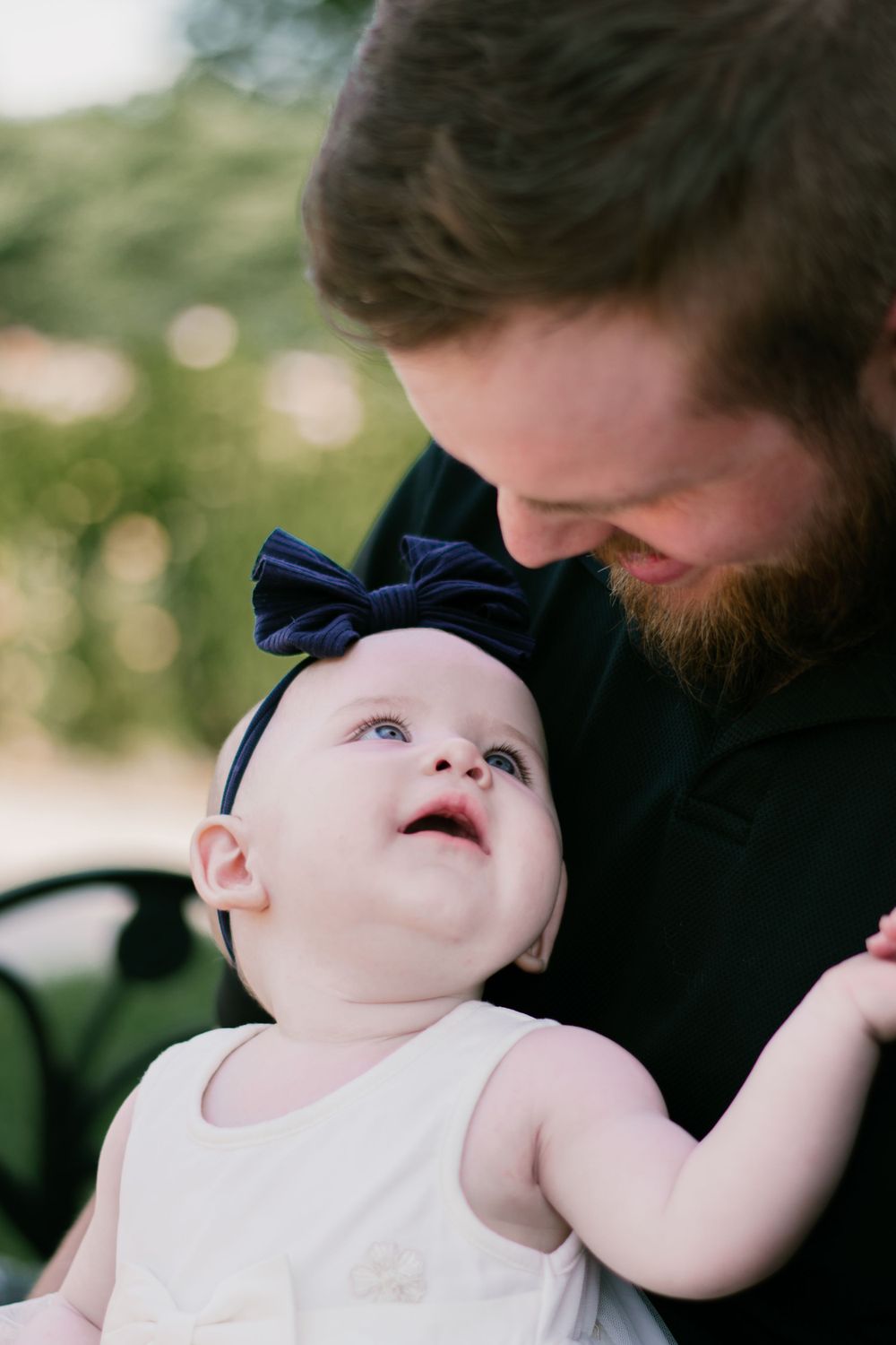 A dad and his baby steal sweet glances at each other