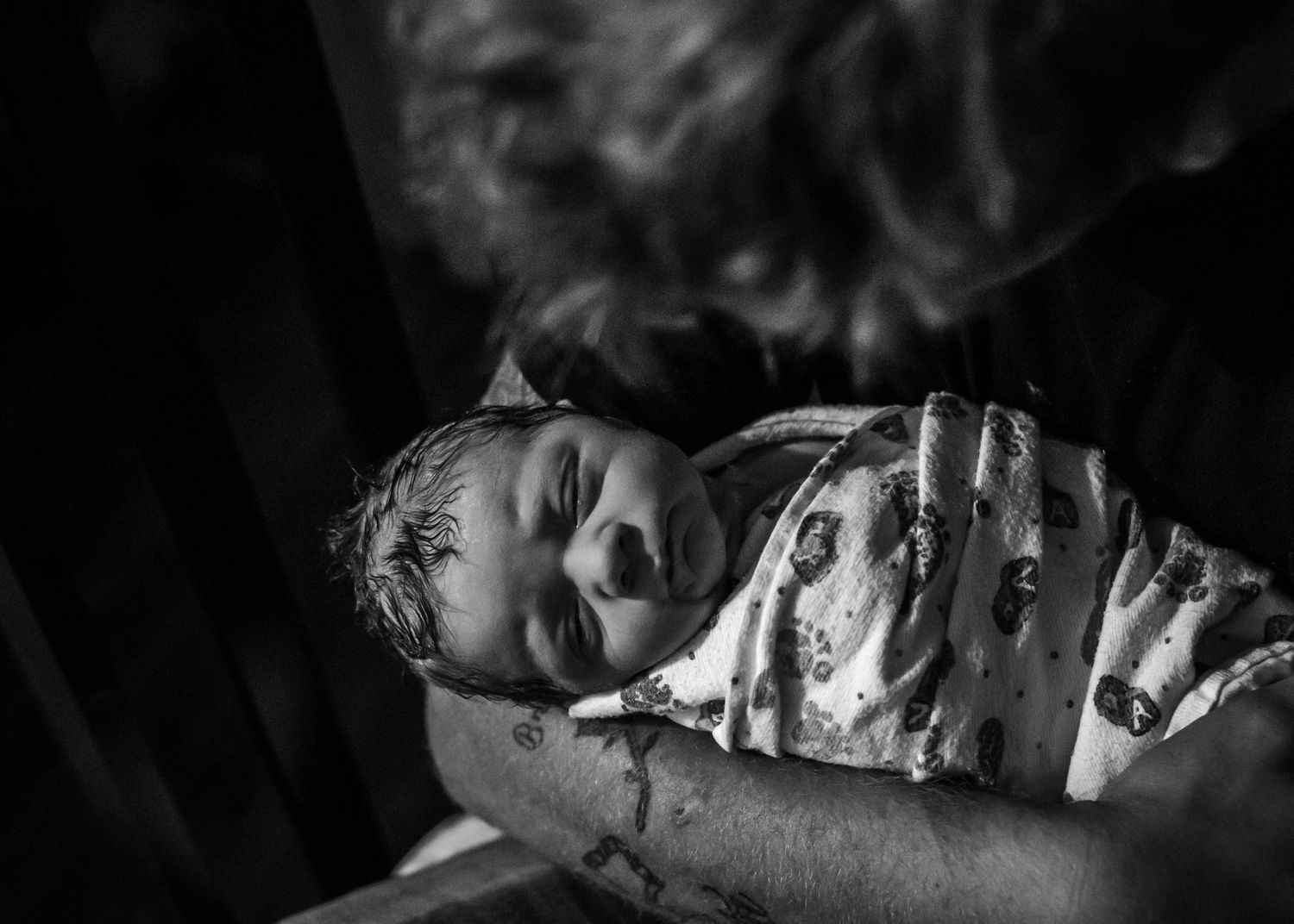 Dad holding his new baby boy for the first time just moments after birth in Sioux City, IA.