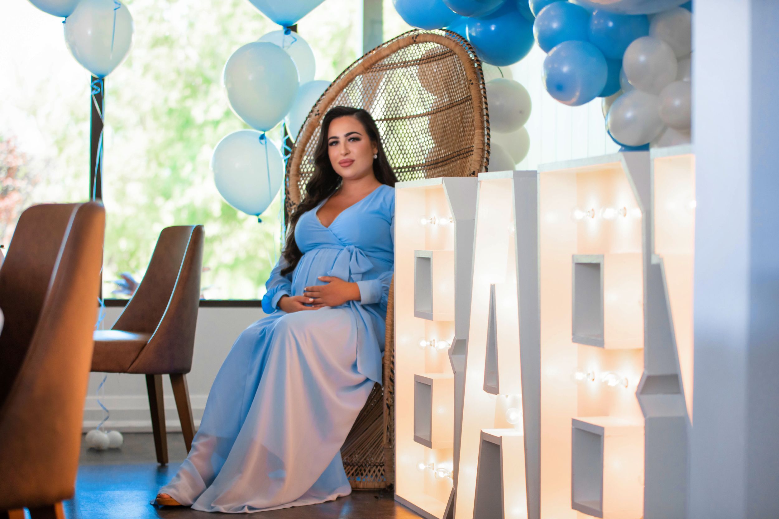 Party room decorated with blue and white balloons for a celebration.