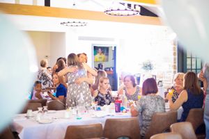 Event space with guests seated at tables during a celebration.