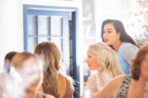 People gathered at a bright, window-lit venue for a special event.