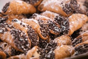 Close-up of chocolate-covered pastries with powdered sugar dusting.