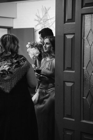 Black and white candid shots of guests mingling at a formal gathering.