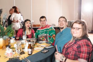 Group enjoying a festive dinner gathering with holiday decorations.