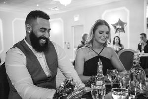 Guests enjoying dinner and conversation at an elegant reception.