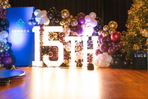 Event stage with illuminated Seneca signage and elegant balloon arch display.