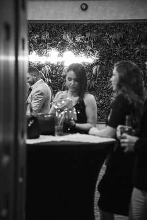 Black and white photo of people enjoying an evening party outdoors.