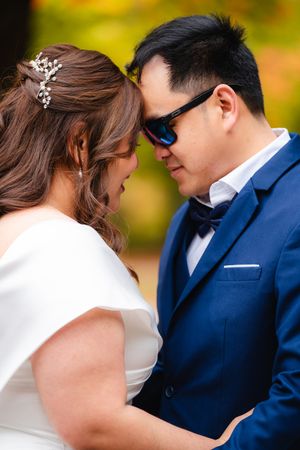 Groom and Bride looking at eachother in autumn