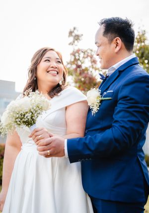 Groom and Bride looking at each other while holding hands
