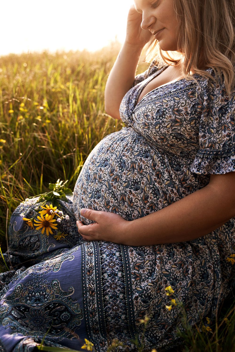 Golden hour maternity photo at Outer Harbor in Buffalo, NY, capturing a glowing expectant mom.