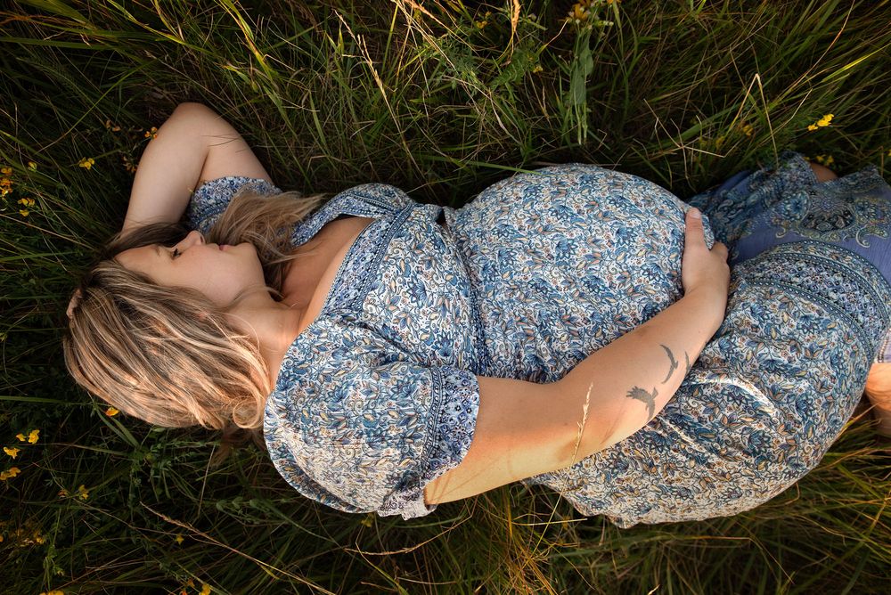 Golden hour maternity photo at Outer Harbor in Buffalo, NY, capturing a glowing expectant mom.