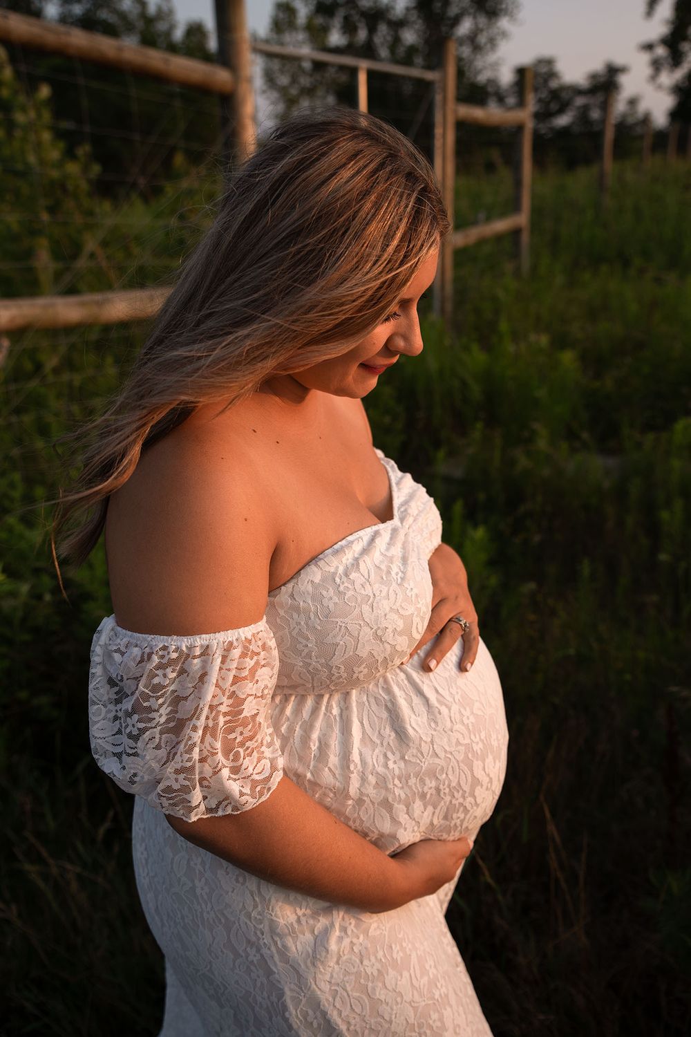 Golden hour maternity photo at Outer Harbor in Buffalo, NY, capturing a glowing expectant mom.