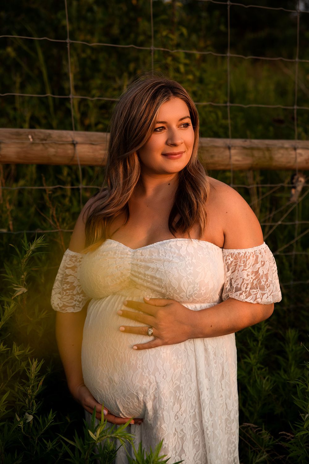 Golden hour maternity photo at Outer Harbor in Buffalo, NY, capturing a glowing expectant mom.