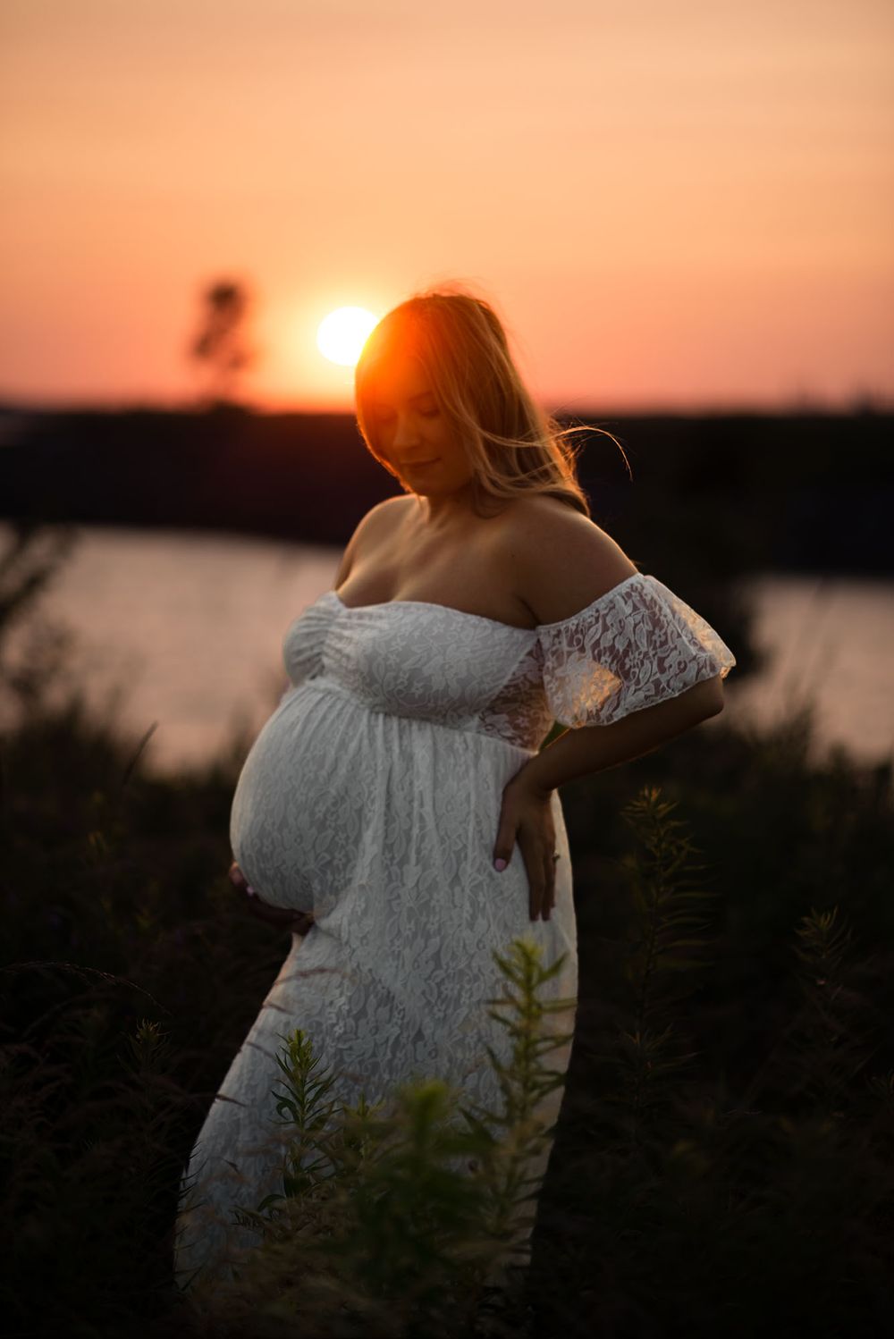 Golden hour maternity photo at Outer Harbor in Buffalo, NY, capturing a glowing expectant mom.