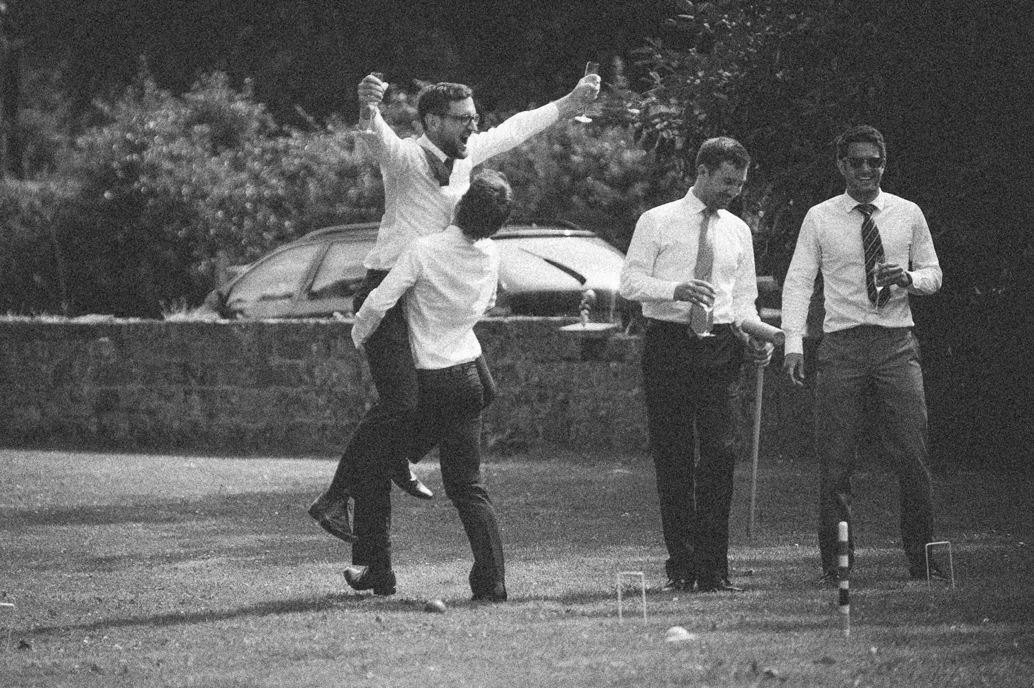 Reportage detail shot of guests enjoying the reception and lawn games