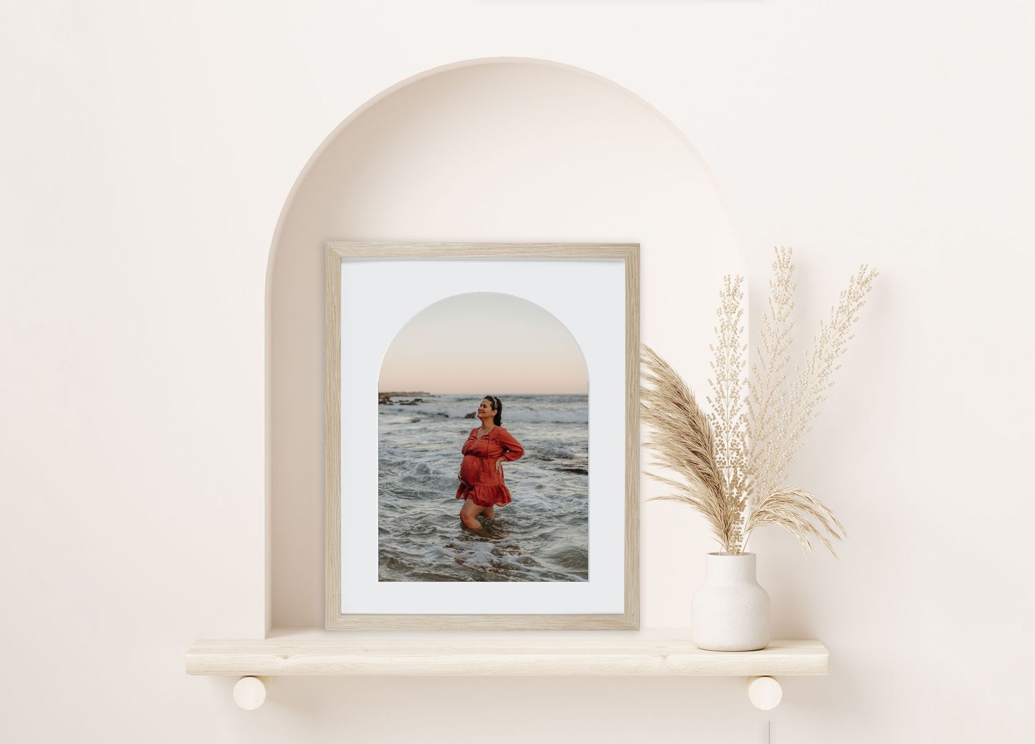 maternity beach photo in arch frame