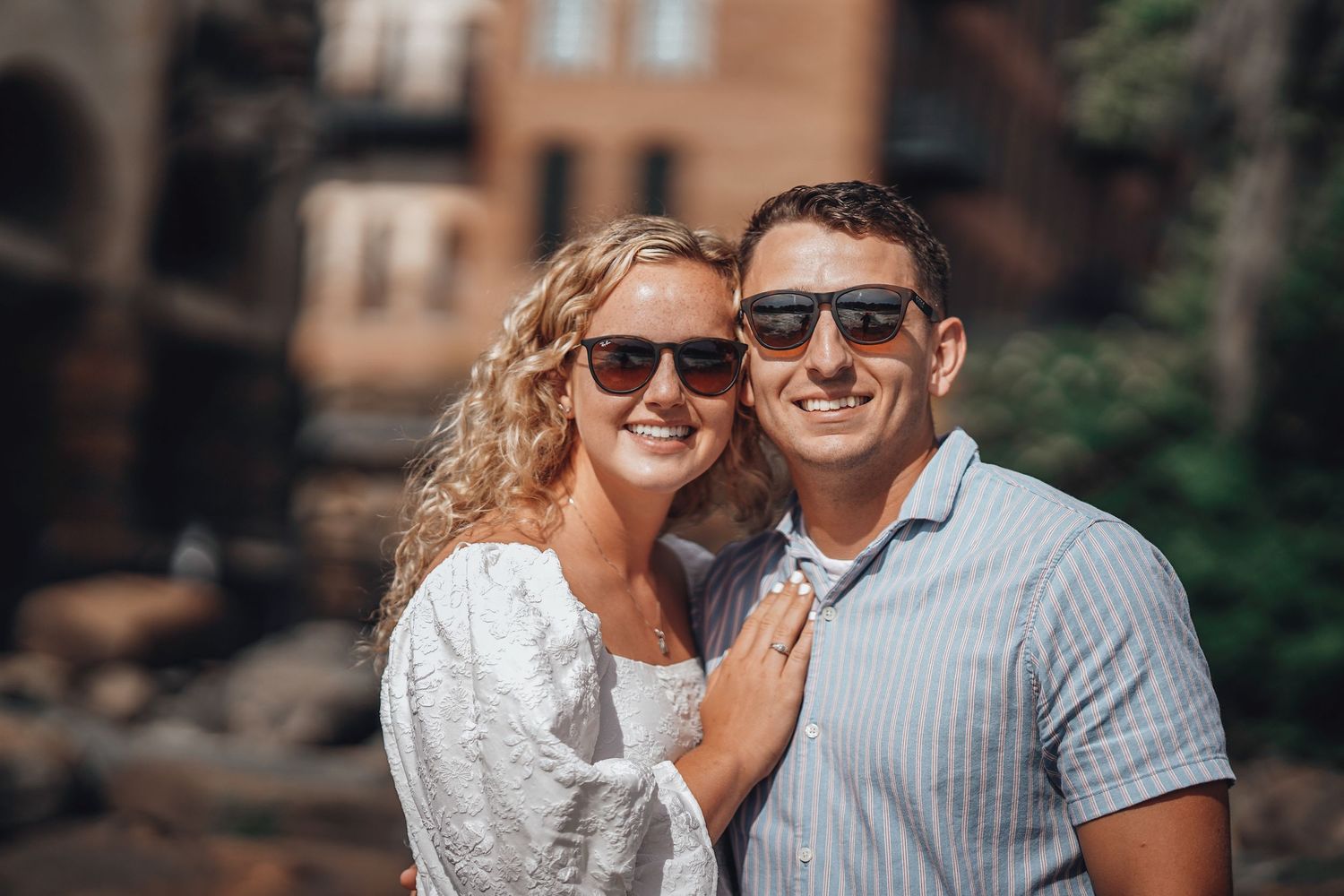 Couple in casual attire sharing joyful moment outdoors.