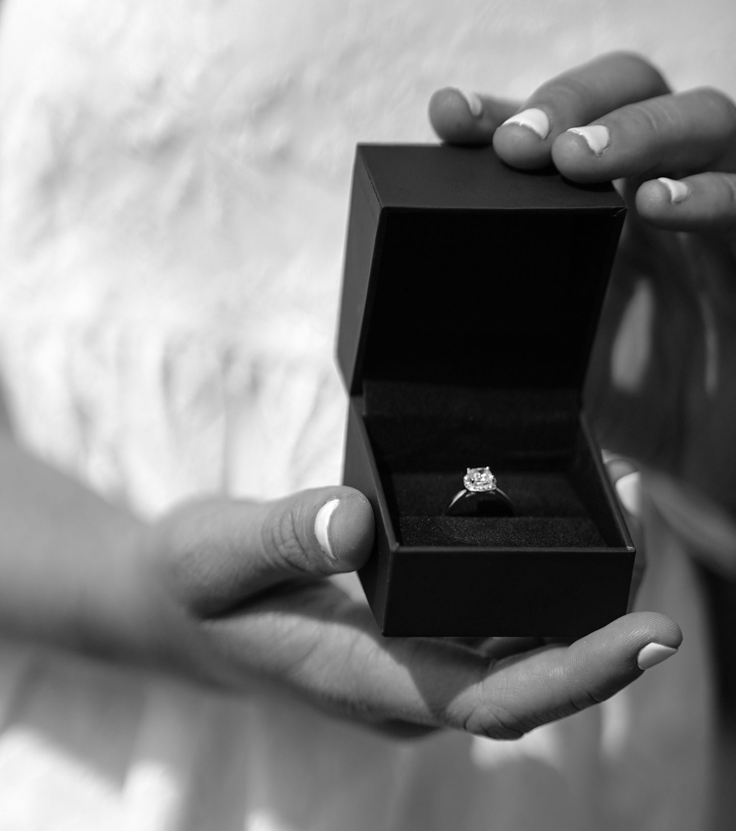 Series of black and white photos showing engagement ring box opening sequence.