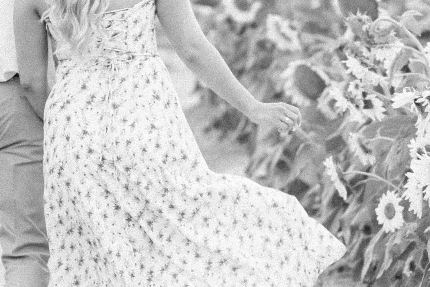 woman's hand touching flowers