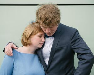 An intimate moment captured between a couple in formal attire.