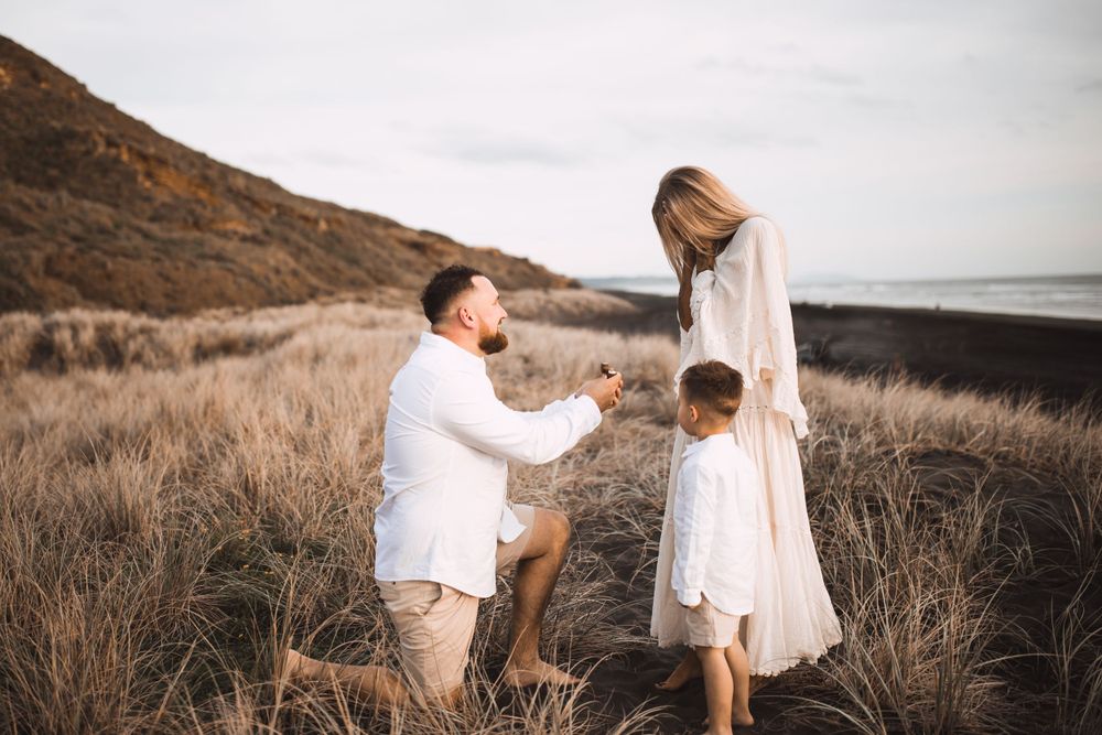 Candid family photos captured during golden hour on scenic coastal hill.