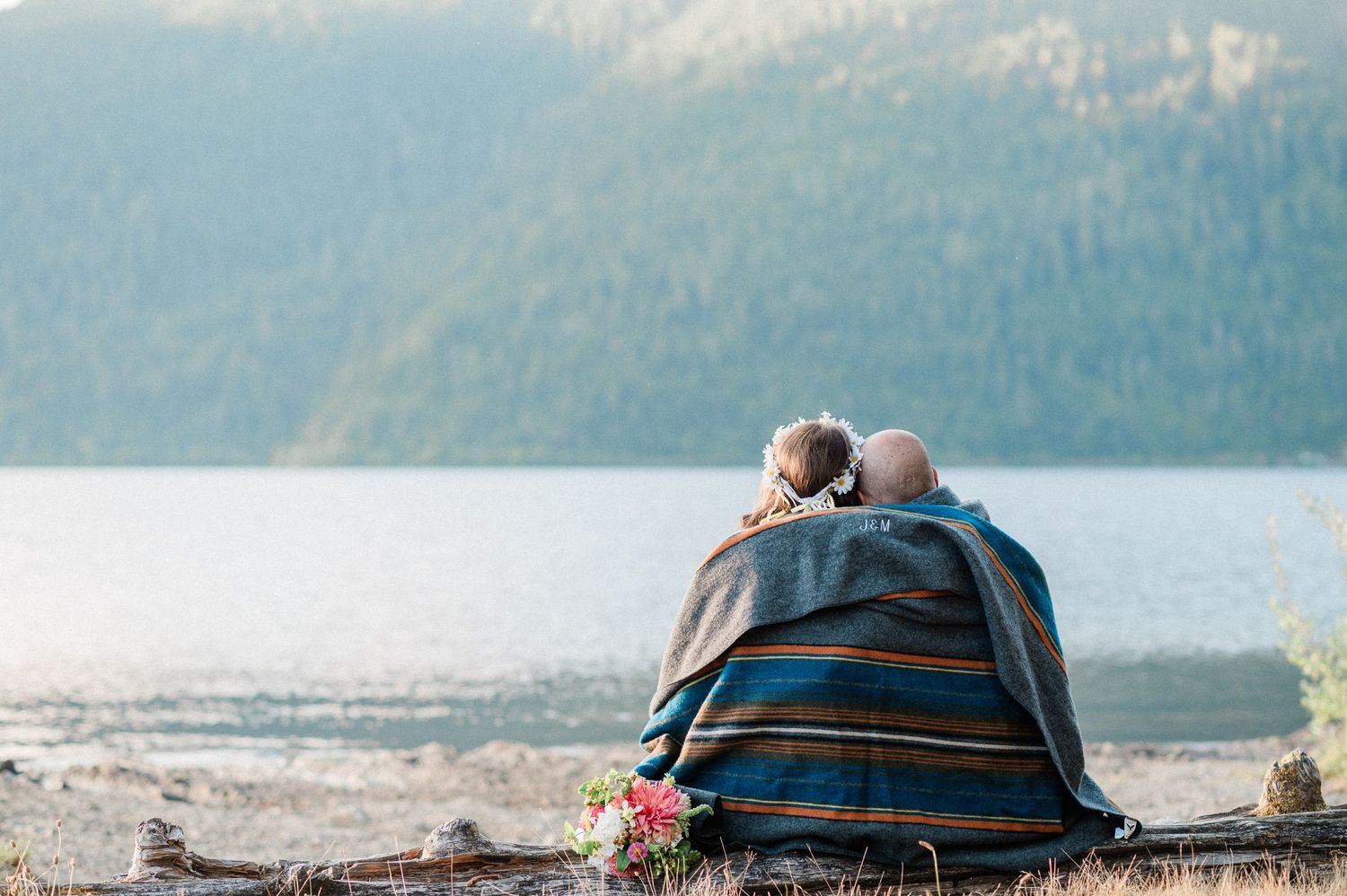 couple snuggling together under blanket during their Olympic National Park elopement